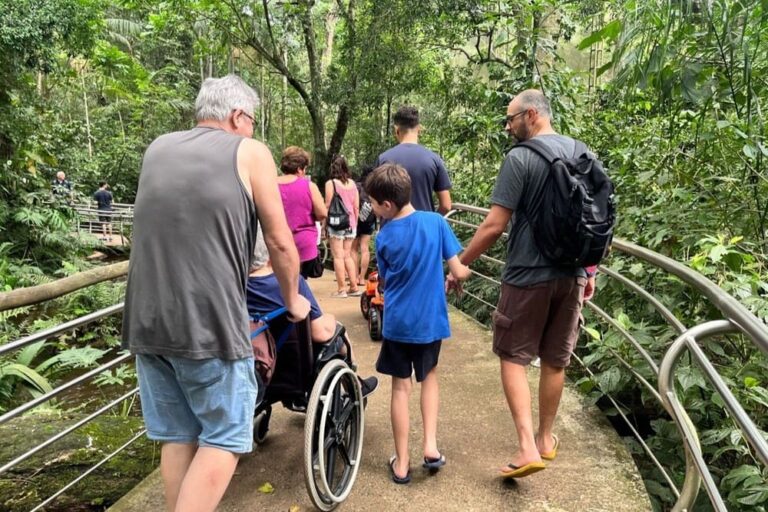 Visitors on an accessible trail at the Bird Park in Foz do Iguacu, including a wheelchair user.